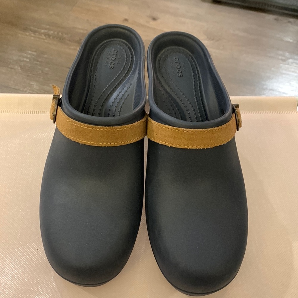 2 pair of Croc clogs size 8 M. 1 pair blue hard leather 1 pair hazelnut suede.